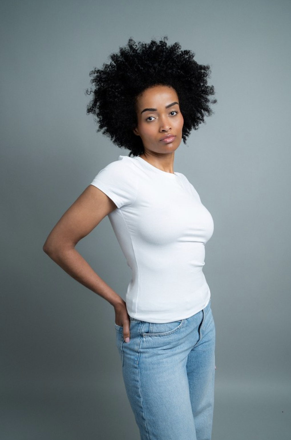 Mimi in a fitted white tee and pale denim, studio test shot